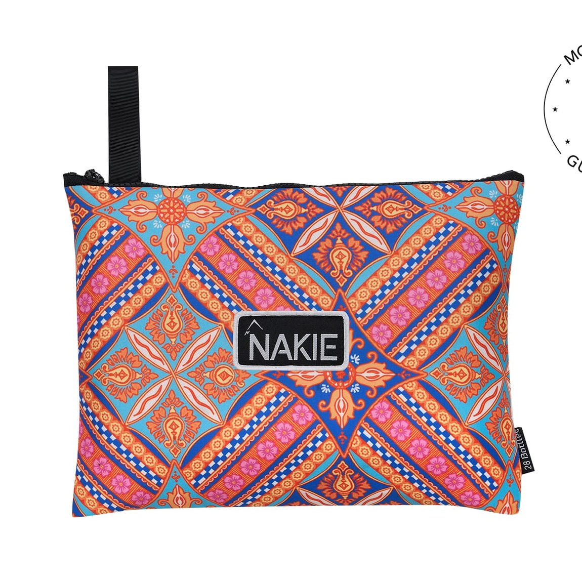 Colorful geometric patterned beach towel in blue, orange, and pink with black carry handle and NAKIE logo label.